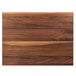 A John Boos black walnut wood cutting board on a table.