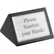 A black wood American Metalcraft tabletop sign with silver text on both sides that says "Please Sanitize Your Hands"