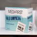 A white and yellow box of Medique Medi-First Instant Ice Packs on a shelf.