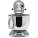 A silver KitchenAid Artisan stand mixer with a round top.