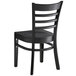 A Lancaster Table & Seating black wooden chair with a wooden back and seat.