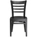 A Lancaster Table & Seating black wooden chair with black seat and back.