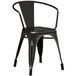 A Lancaster Table & Seating black metal outdoor arm chair.