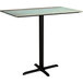 A Lancaster Table & Seating rectangular bar height table with a metal base and a textured canyon painted top.