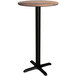 A wood grained round bar height table with a black pole.