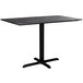 A black rectangular Lancaster Table & Seating dining table with a metal cross base.