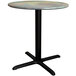 A Lancaster Table & Seating round dining table with a textured canyon metal finish and a cross base plate.