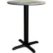 A round Lancaster Table & Seating dining table with a black base.