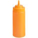A yellow plastic Choice wide mouth squeeze bottle filled with orange sauce.