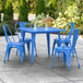 A blue metal table with blue chairs on an outdoor patio.