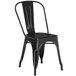 A black metal Lancaster Table & Seating cafe chair.