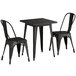 A black Lancaster Table & Seating outdoor table with 2 chairs.