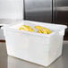 A white Carlisle StorPlus food storage box filled with bananas.