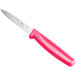 A Choice paring knife with a serrated edge and a neon pink handle.