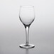 A Nude Primeur wine glass on a white surface.