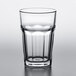 A close-up of a Pasabahce clear beverage glass on a table.