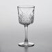 A close-up of a Pasabahce Timeless Vintage wine glass with a diamond pattern.