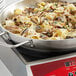 A Vigor SS1 Series stainless steel fry pan filled with pasta and mushrooms.