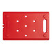 A red plastic board with holes for food pans.