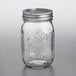 A Ball glass canning jar with a silver metal lid and band with stars and stripes on it.