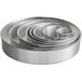 A stack of round silver metal Choice mini cake pans.