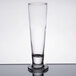 A Libbey tall footed pilsner glass on a table.