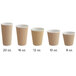 A row of Choice brown double wall ripple paper hot cups with a white rim.