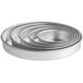 A stack of round silver Choice aluminum cake pans.