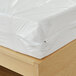 A Bargoose long full mattress with a white plastic zippered cover.