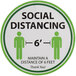 A white Tablecraft floor decal with green text that says "Social Distancing" above footprints.
