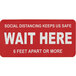 A red Tablecraft "Wait Here" social distancing floor decal with white text.