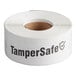 A roll of white TamperSafe labels with black text.