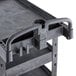 A black plastic utility cart with an ergonomic handle and shelves.