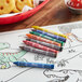 Choice green crayons on a coloring page on a table in a farm-to-table restaurant.