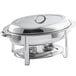 A silver stainless steel Choice Deluxe oval chafer with chrome accents on a table.