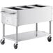 A stainless steel mobile steam table with three compartments and wheels.