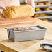 A rectangular glazed aluminized steel bread loaf pan measuring 8 inches by 4 inches by 2.5 inches.