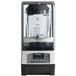 A Vitamix T&G Advance blending station with a clear container and black and white lid.
