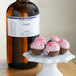 A bottle of LorAnn Oils Teaberry Flavor next to chocolate truffles.