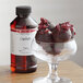 A glass of chocolate balls with LorAnn Oils Cranberry Flavor on the counter.