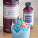 A cupcake with blue frosting and sprinkles with LorAnn Oils Princess Cake and Cookie Bakery Emulsion.
