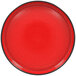A white porcelain plate with a red center and black rim.