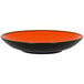 An orange and black RAK Porcelain deep coupe plate.