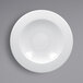 A white plate with a circular design on a white surface.