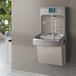 An Elkay water fountain with a faucet and a digital display on the wall.