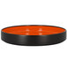 A black and orange RAK Porcelain deep plate with a black rim.