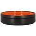 An orange rimless porcelain deep plate with a lid.