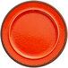 An orange RAK Porcelain plate with a black rim.