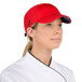 A chef wearing a red Headsweats 5-panel cap with a terry sweatband.