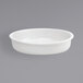 A white round porcelain food pan with a handle.